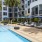 Relax poolside at our apartments in Miami. 