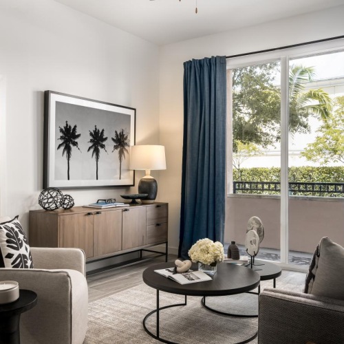 Spacious living room in Miami apartment with floor-to-ceiling glass doors