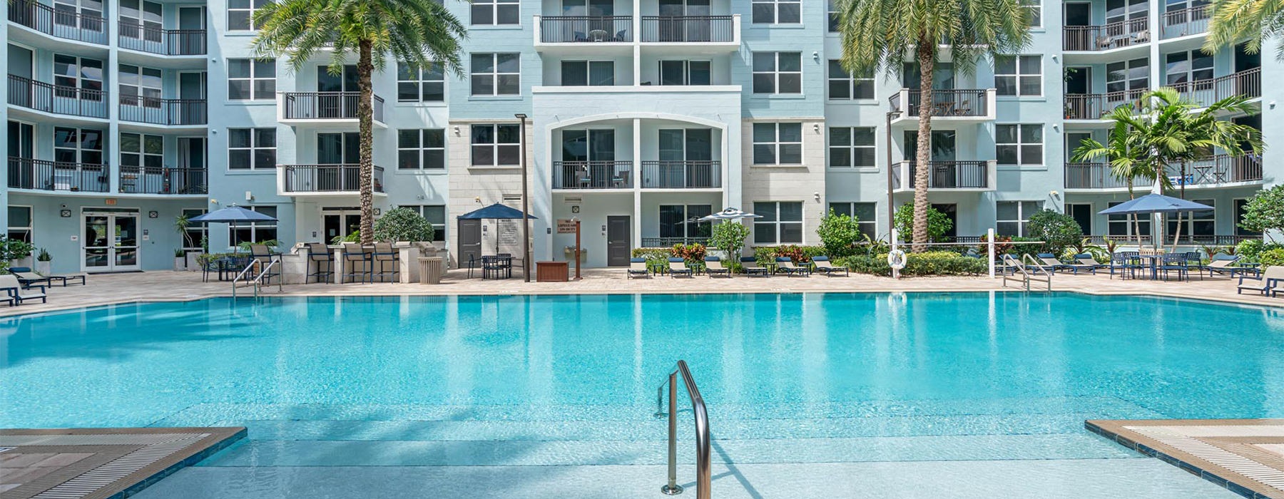 a large building with a pool in front of it